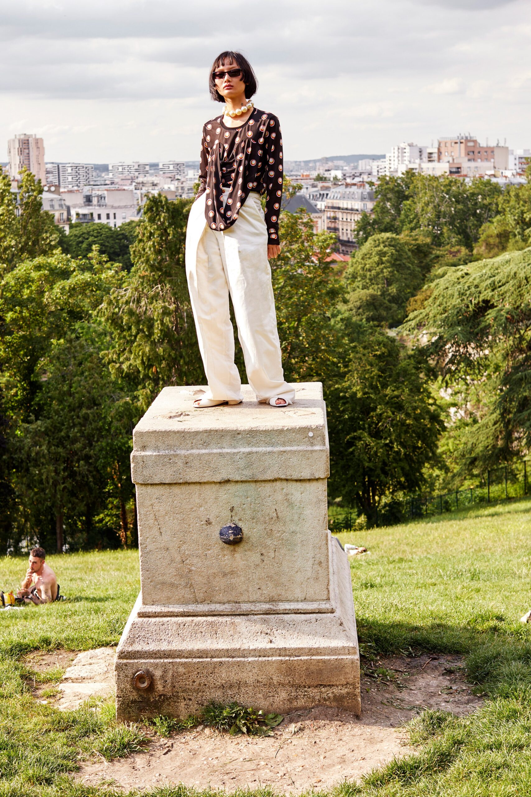 black polka-dot top with white pants