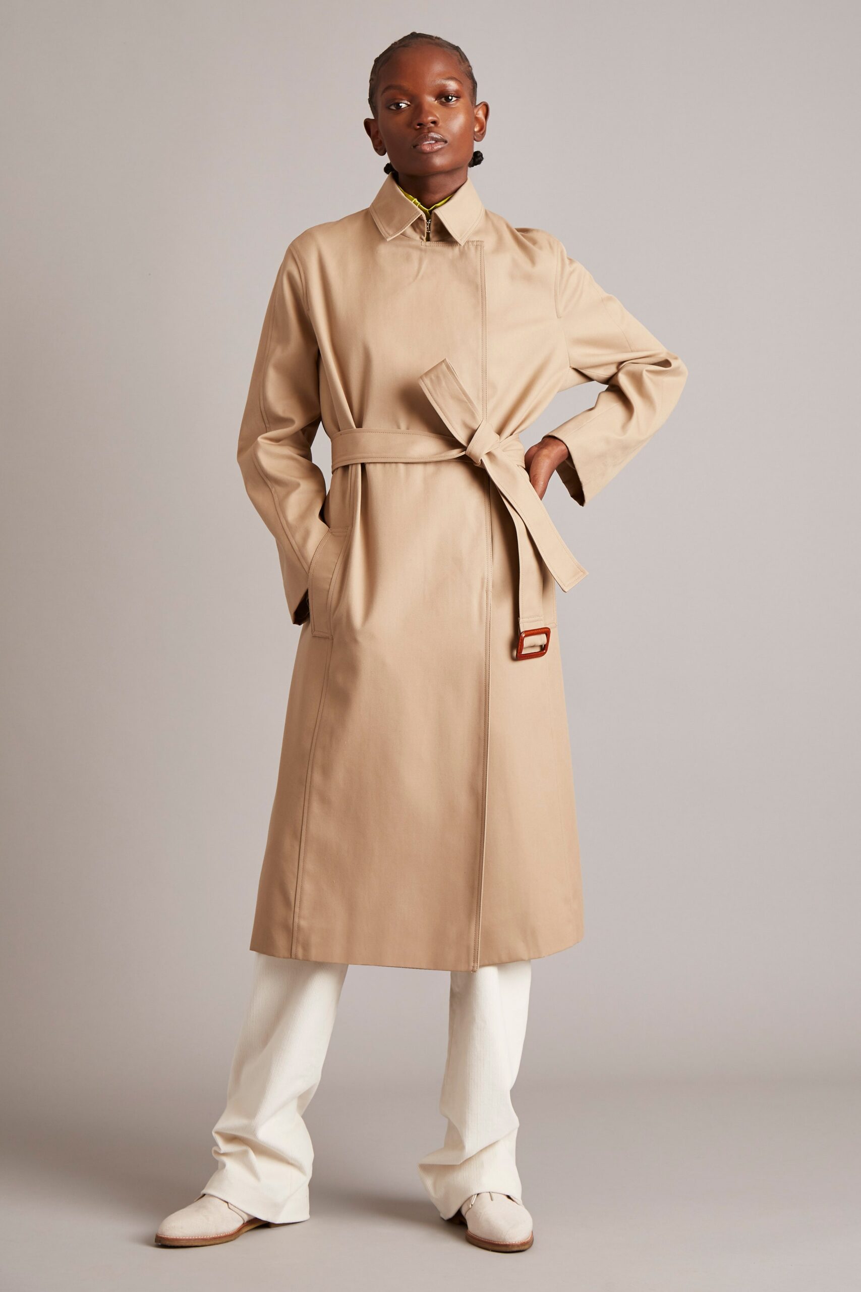 beige tailored trench coat and white pants