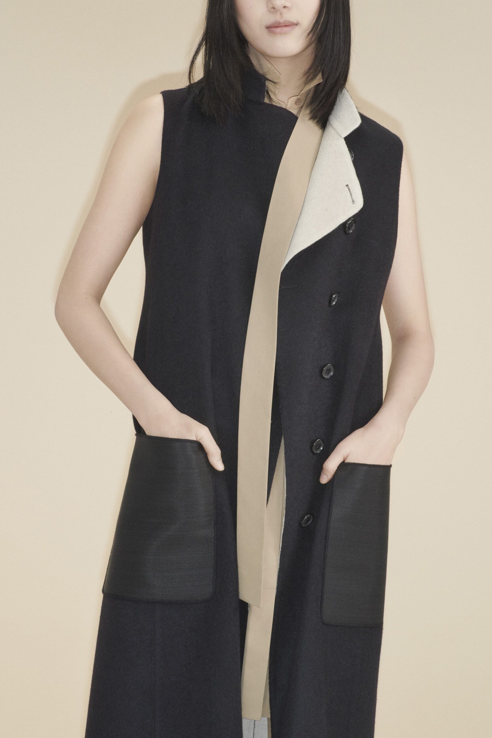 black and beige sleeveless coat