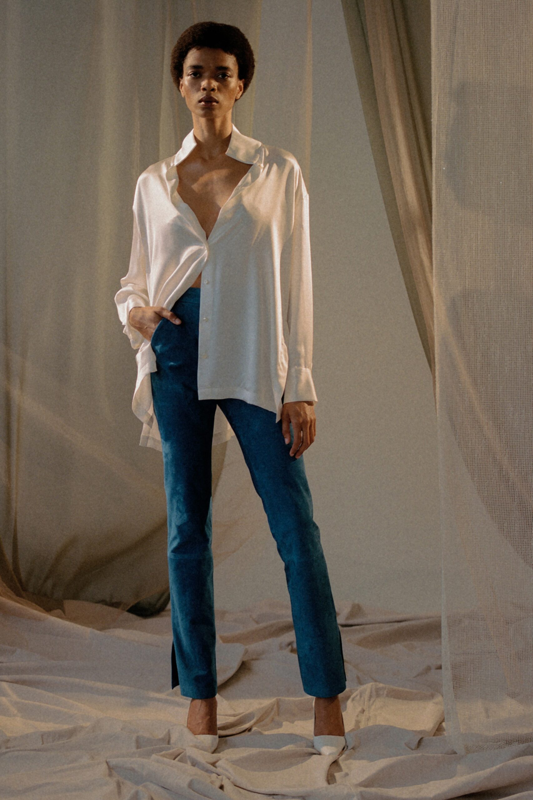 white silk relaxed shirt with blue pants