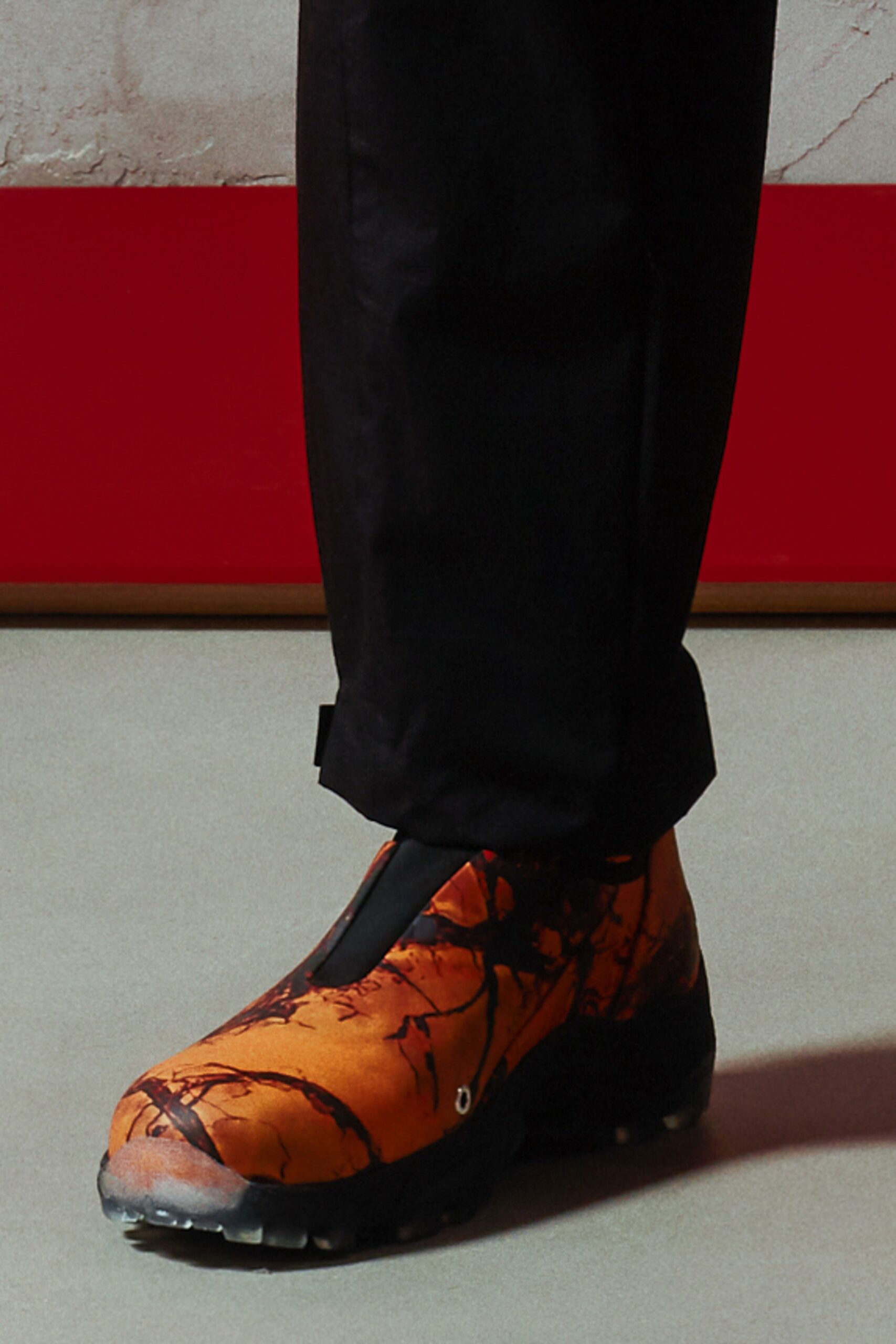 A pair of relaxed black pants featuring a unique printed design.