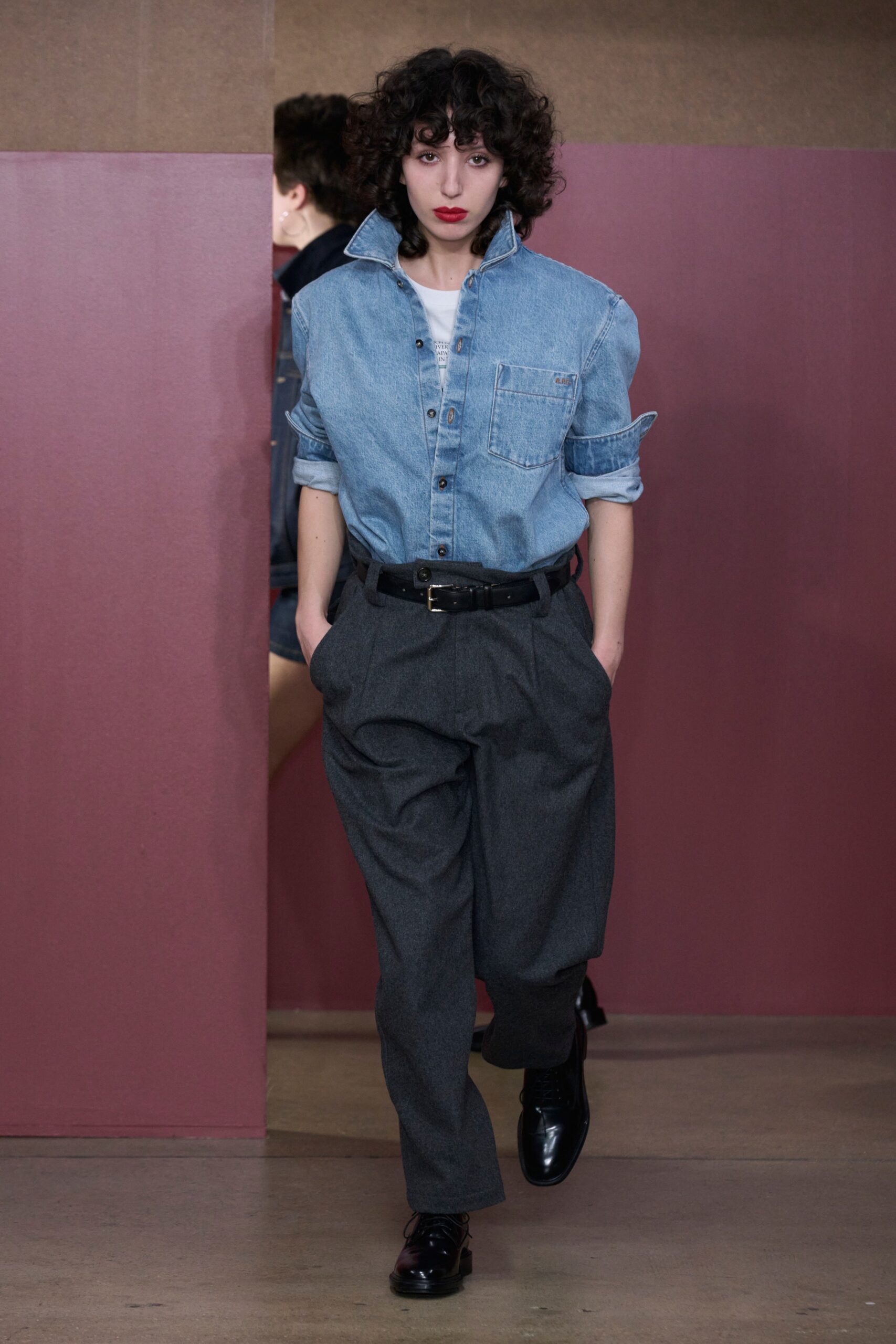 A relaxed blue denim long-sleeve shirt paired with wide-leg gray pants.