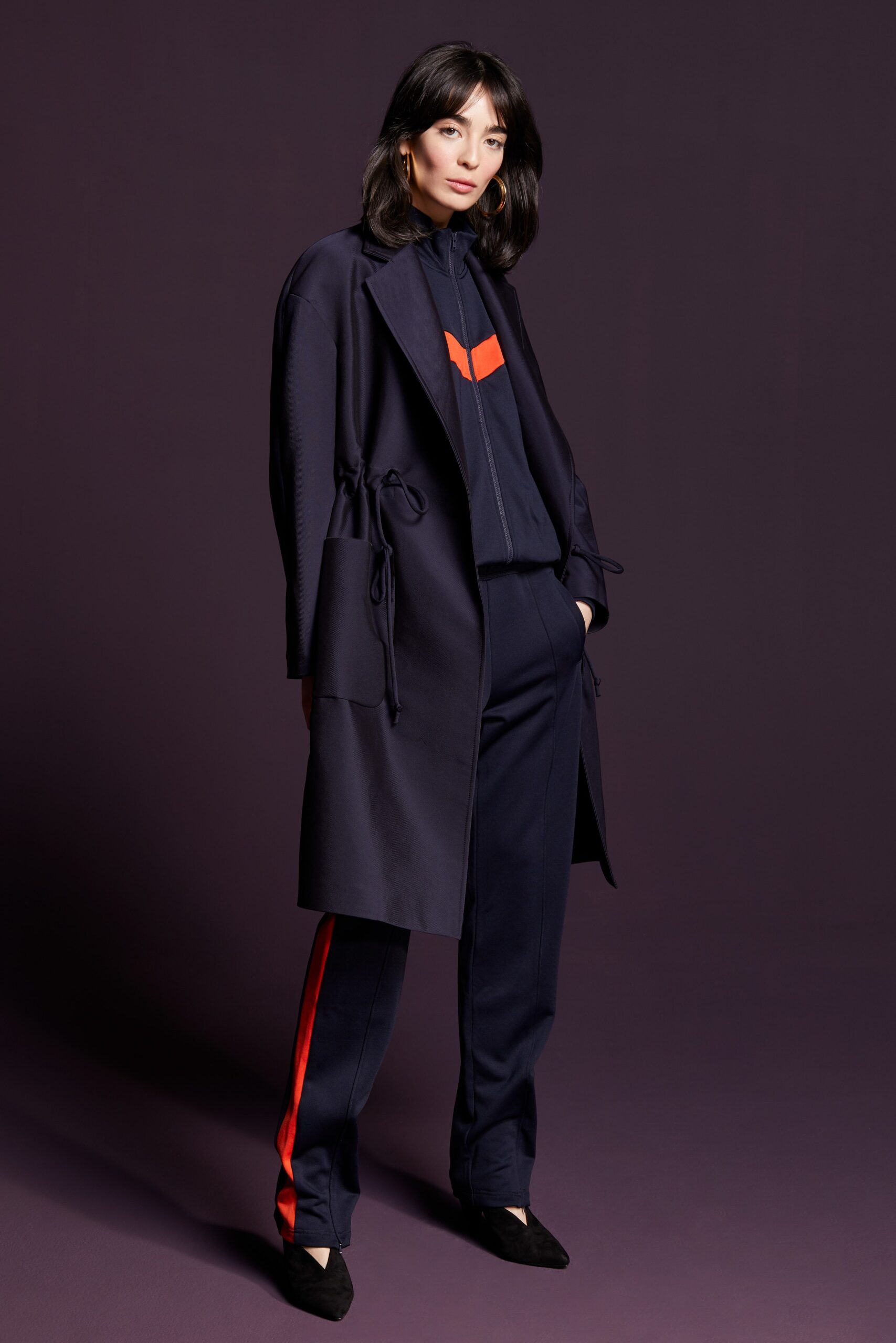 navy coat with black top and tailored pants