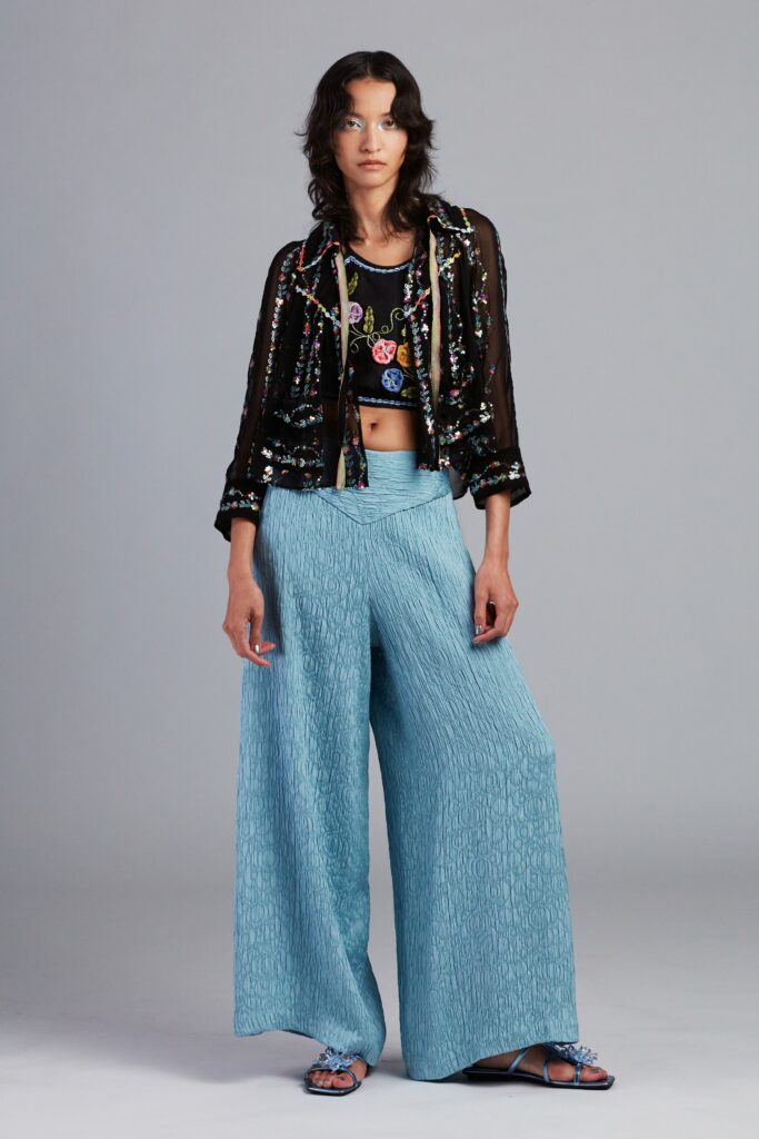 black embroidered jacket with blue pants