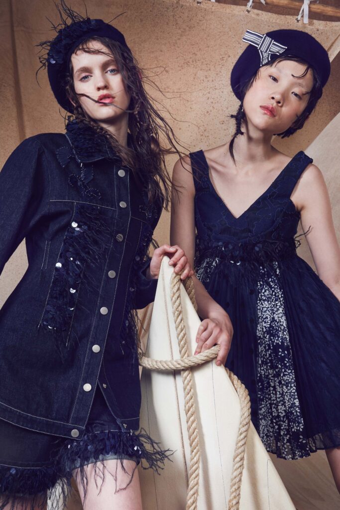 black pleated mini dress and blue denim jacket