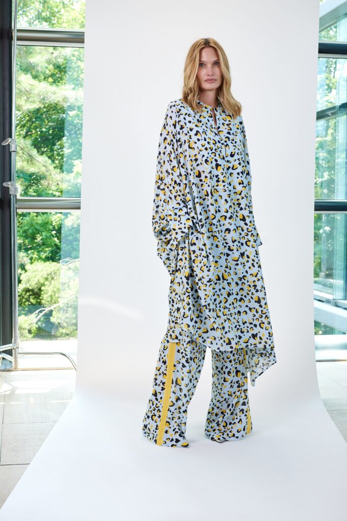 A relaxed blue printed dress with long sleeves and a collared neckline paired with matching pants.