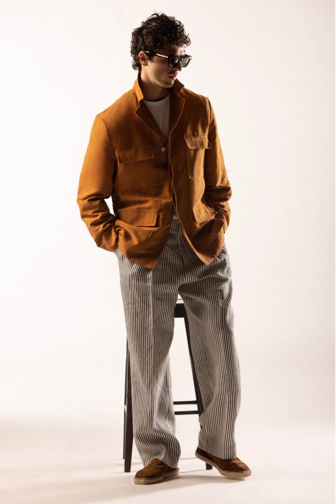 A relaxed brown cotton jacket paired with white striped pants, featuring a long-sleeve and collared design.