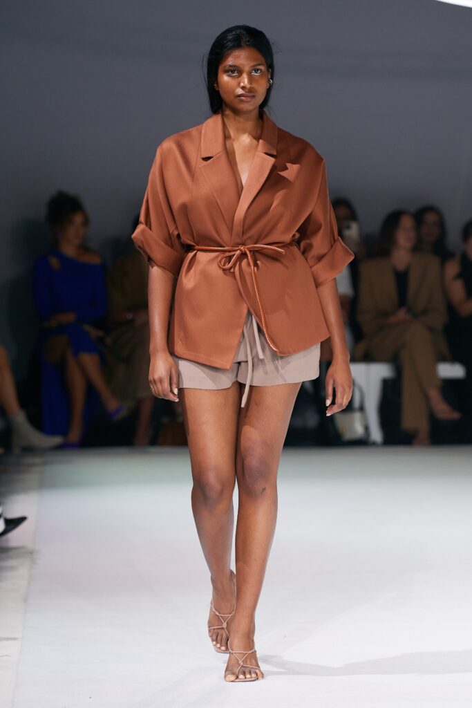 brown silk belted blouse with beige shorts