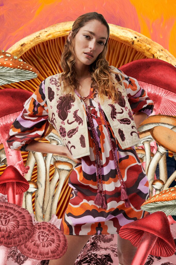 A relaxed multicolor printed dress paired with a long-sleeve collared jacket.