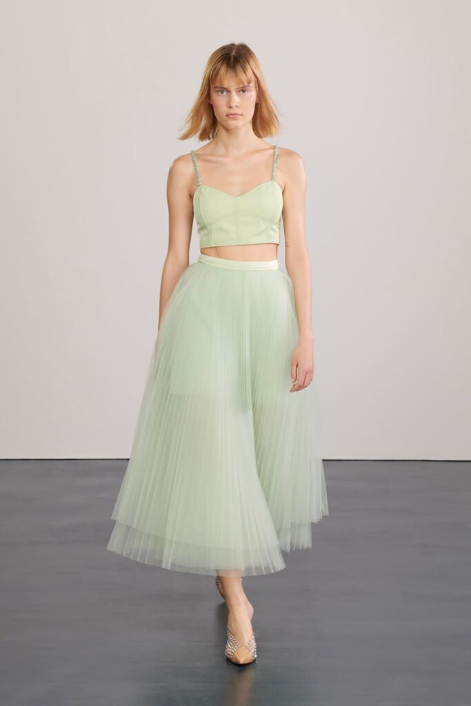 green silk crop-top and pleated skirt
