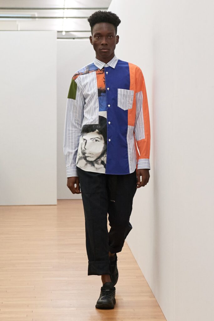 A relaxed fit long-sleeve color-blocked shirt with printed details, paired with black pants.