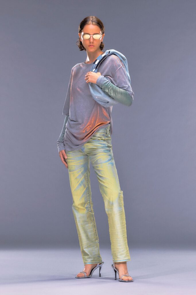 A relaxed blue long-sleeve top paired with yellow pants featuring a layered design.