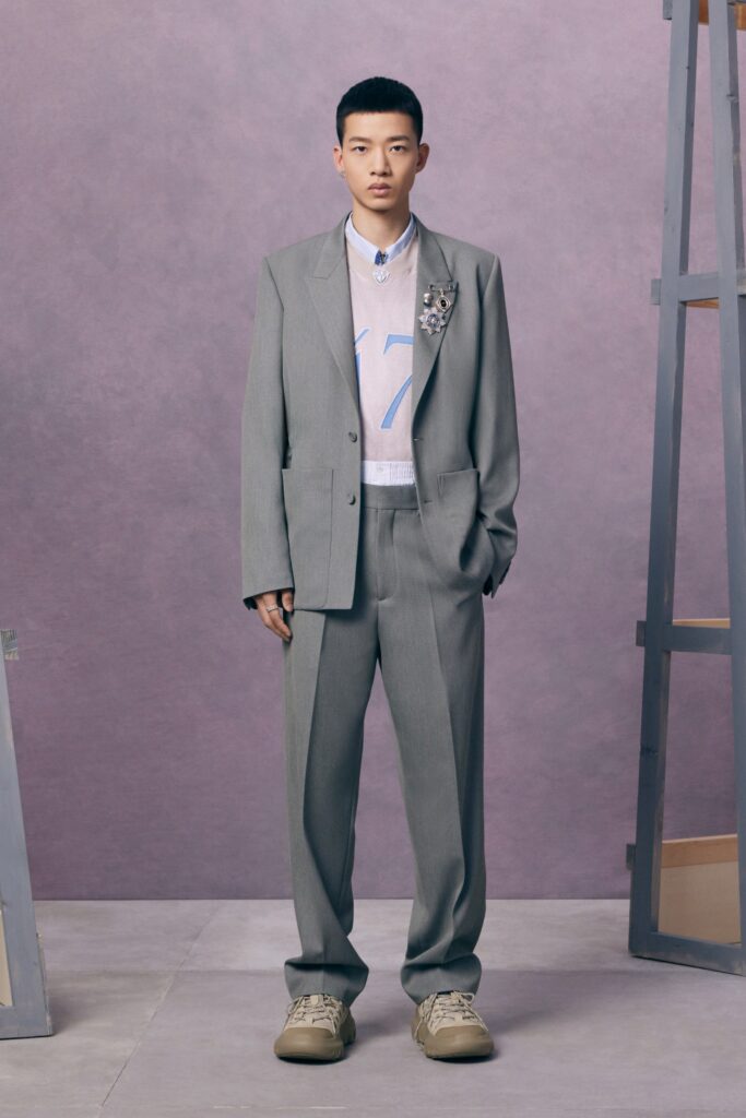 A tailored gray suit with a long-sleeve shirt and stylish sneakers.