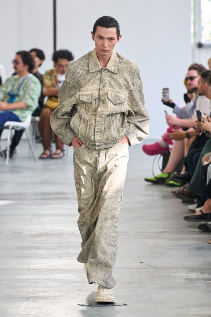 A relaxed beige denim jacket with long sleeves and matching pants, featuring a buttoned design.