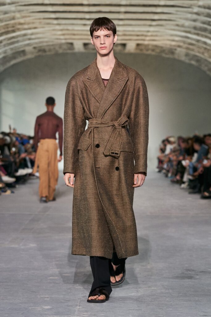 A relaxed brown wool coat with long sleeves and a belted design.