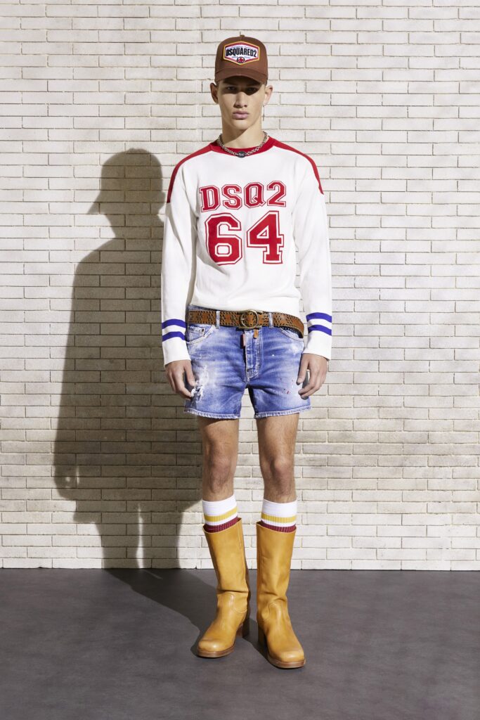 A fitted white short-sleeve shirt paired with blue denim shorts and stylish boots.