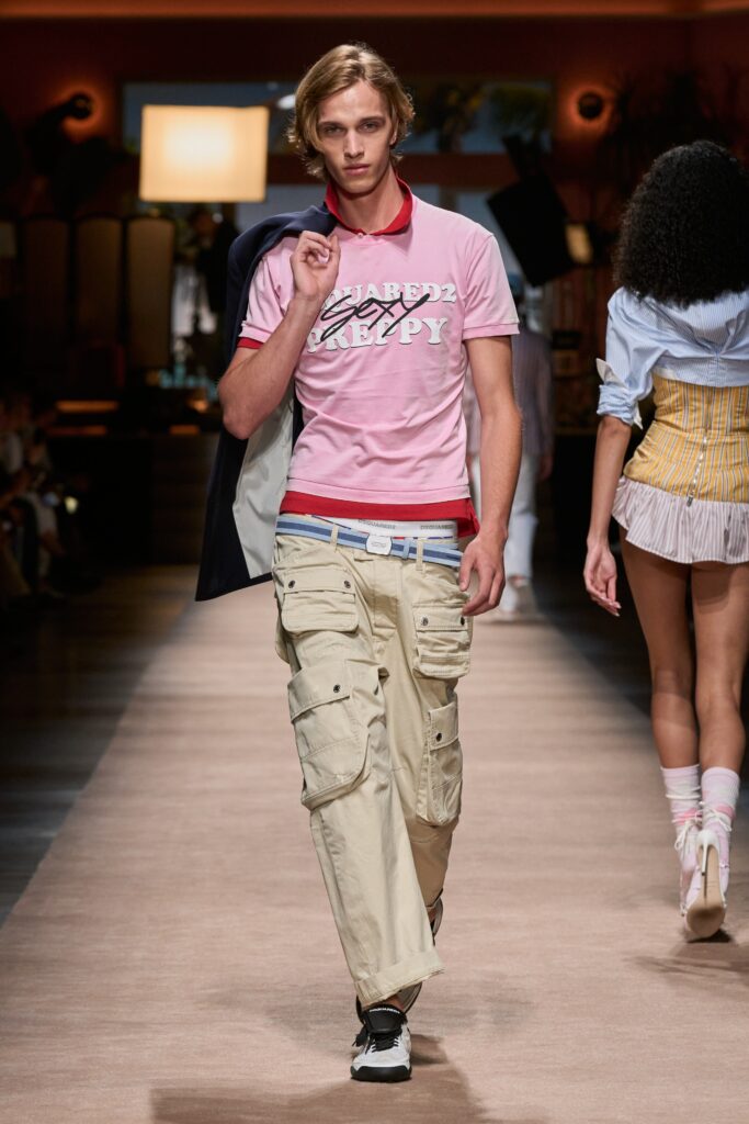 A relaxed pink collared shirt paired with beige cargo pants featuring zippered details.