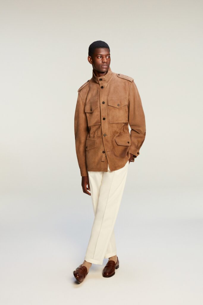 A relaxed brown suede jacket paired with straight-leg white pants for a stylish look.