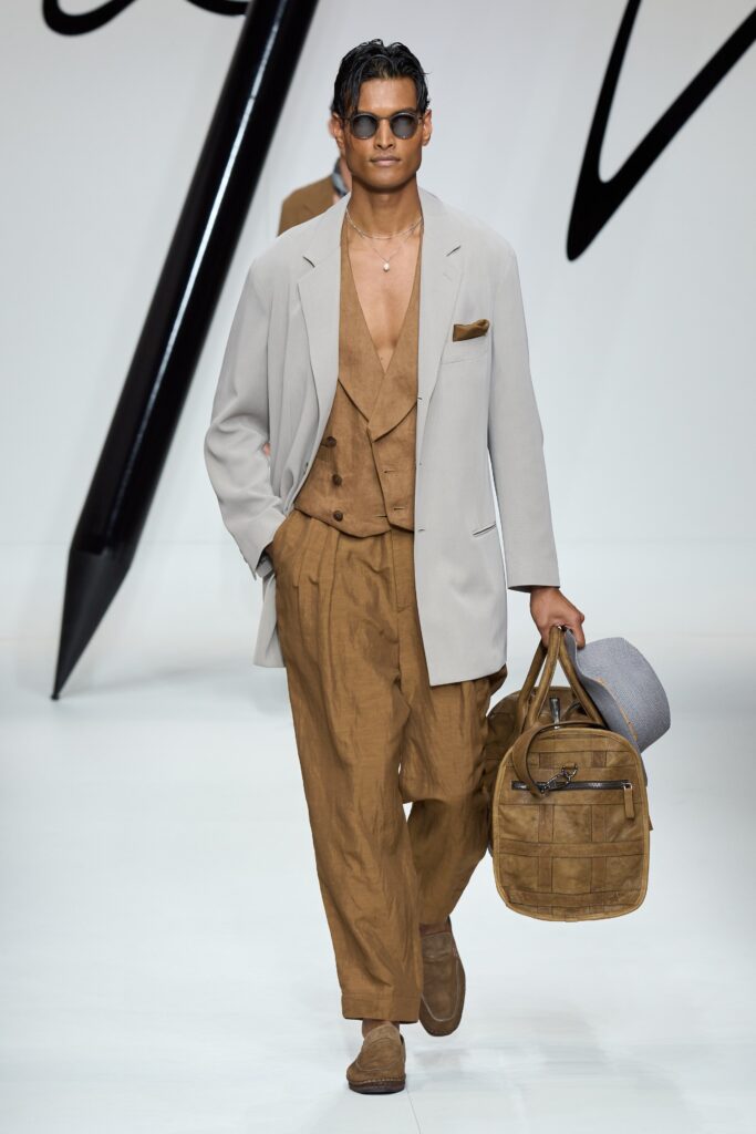 A relaxed brown cotton suit with a collared long-sleeve jacket and straight-leg trousers.