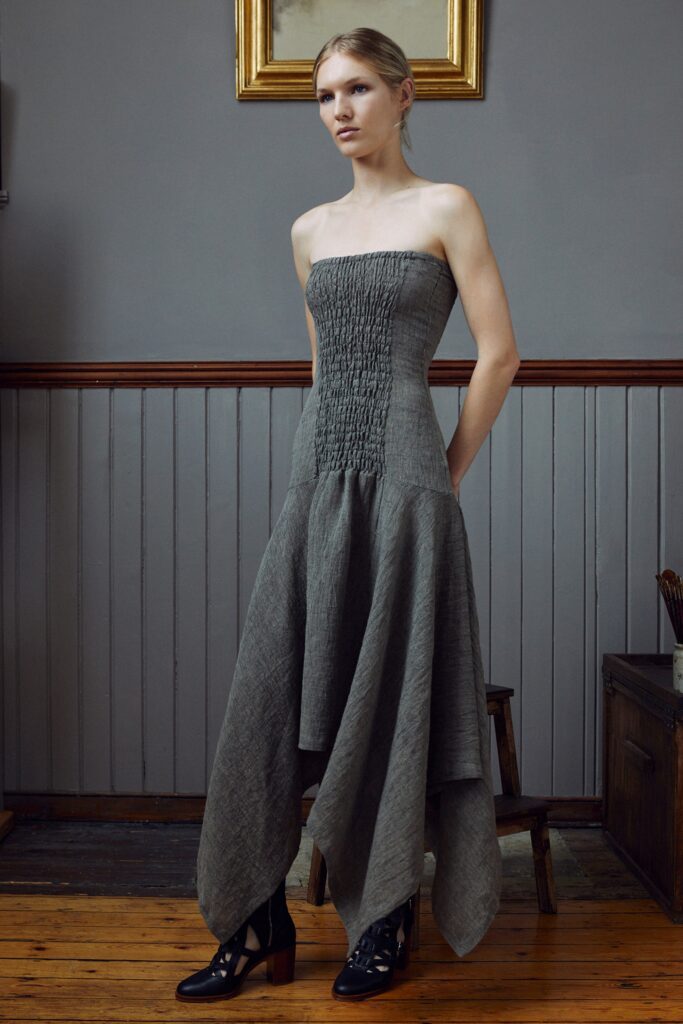 A fitted gray cotton dress with a sleeveless design and asymmetric hemline.
