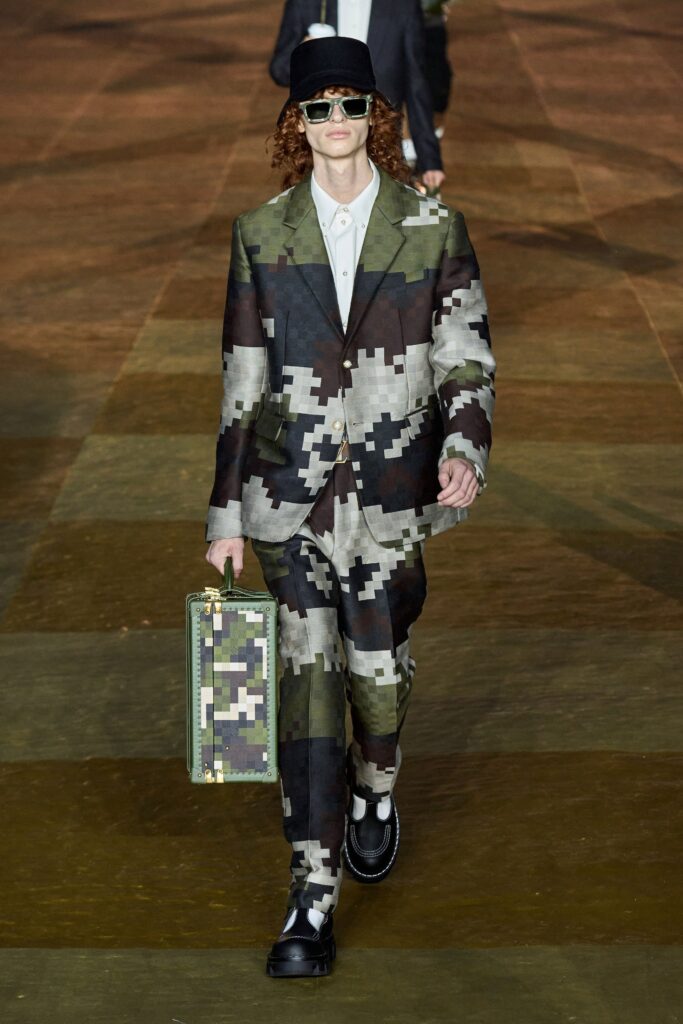 A tailored green and black printed suit with a collared long-sleeve shirt.