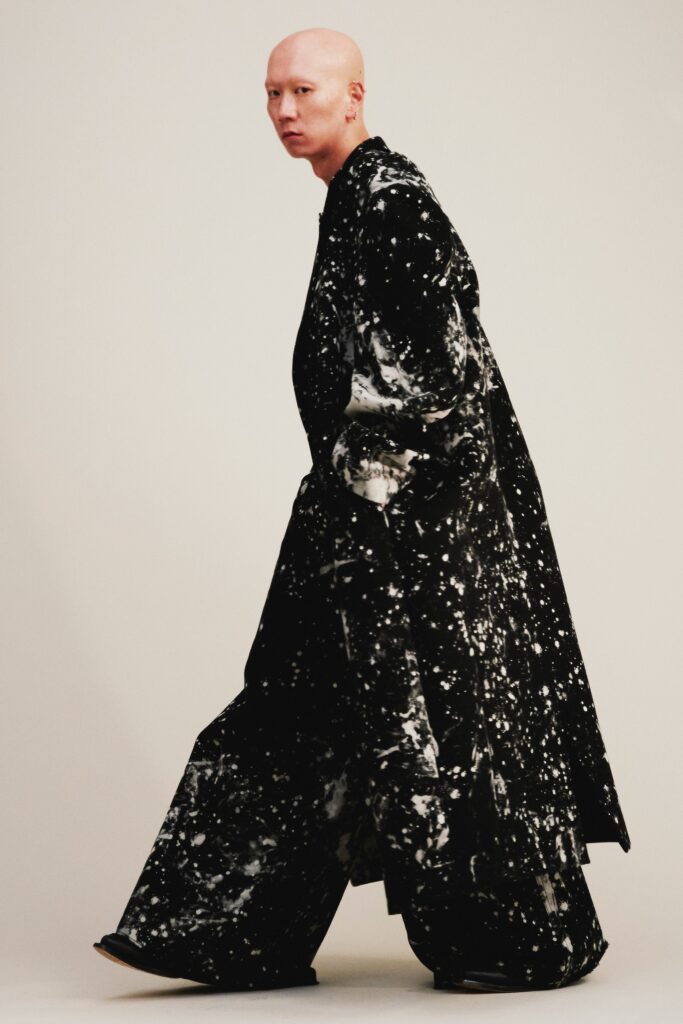 A relaxed black and white printed coat with long sleeves and matching pants.