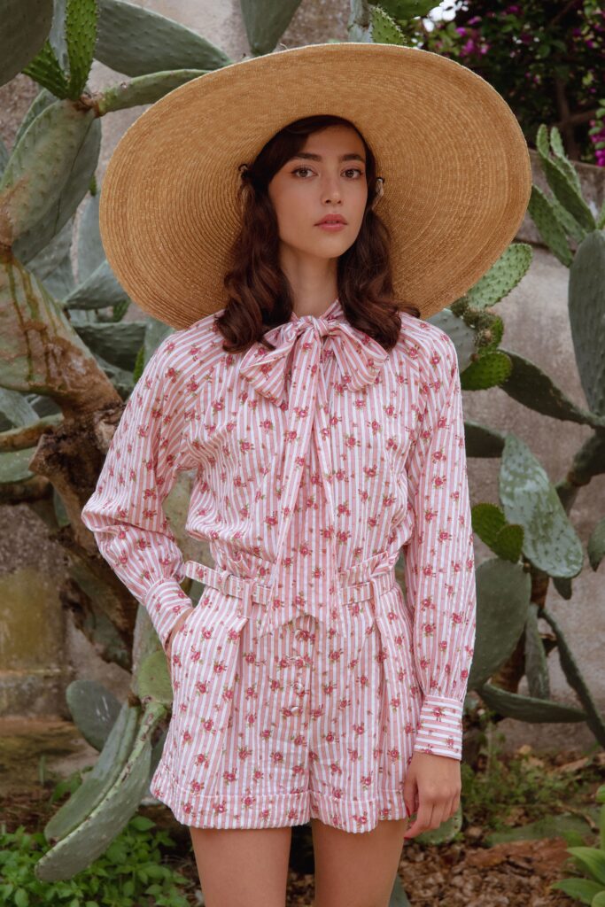 pink floral romper with wide-brimmed hat