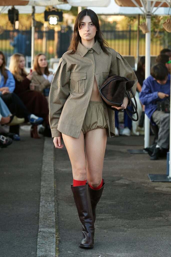 A relaxed brown checked long-sleeve shirt paired with beige shorts.