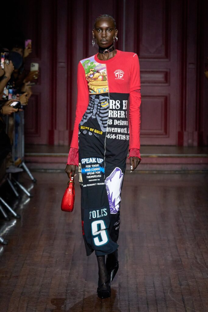A fitted red and black dress with long sleeves and a collared neckline featuring printed details.