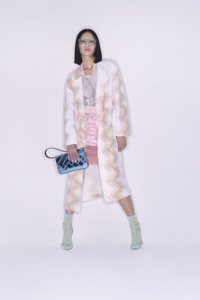 A fitted pink and white striped coat paired with a matching skirt, featuring a collared design.