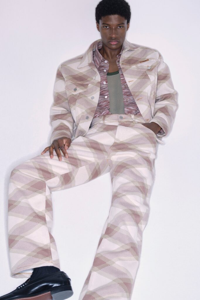 A fitted beige printed denim jacket paired with flared pants for a stylish look.