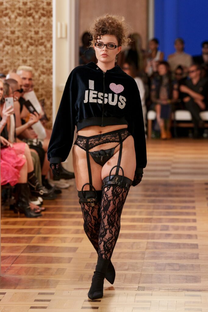 An oversized black hoodie paired with lace pants, creating a bold and edgy look.