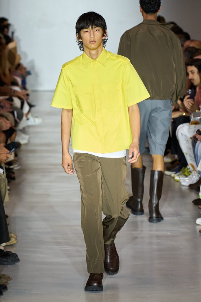 A relaxed yellow cotton short-sleeve shirt paired with straight-leg brown pants.
