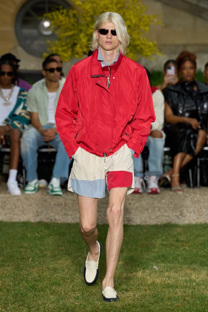 A relaxed-fit red cotton jacket paired with color-blocked shorts for a casual look.
