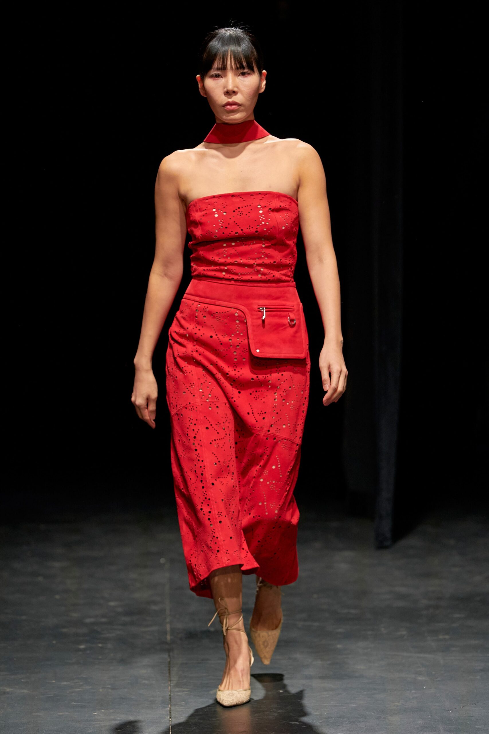 A fitted red strapless dress with a tiered design, perfect for a fashion-forward look.