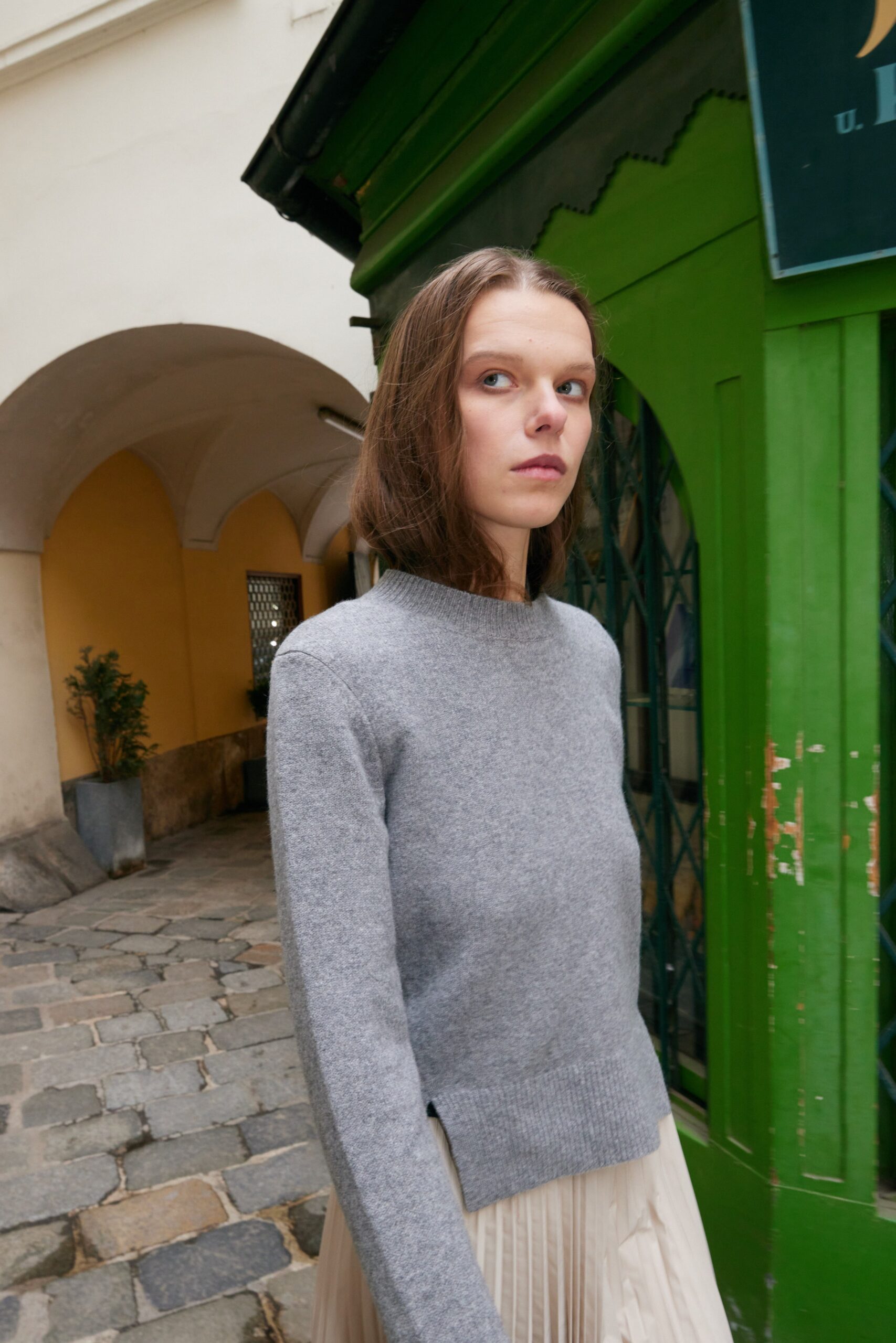 gray wool sweater and beige pleated skirt