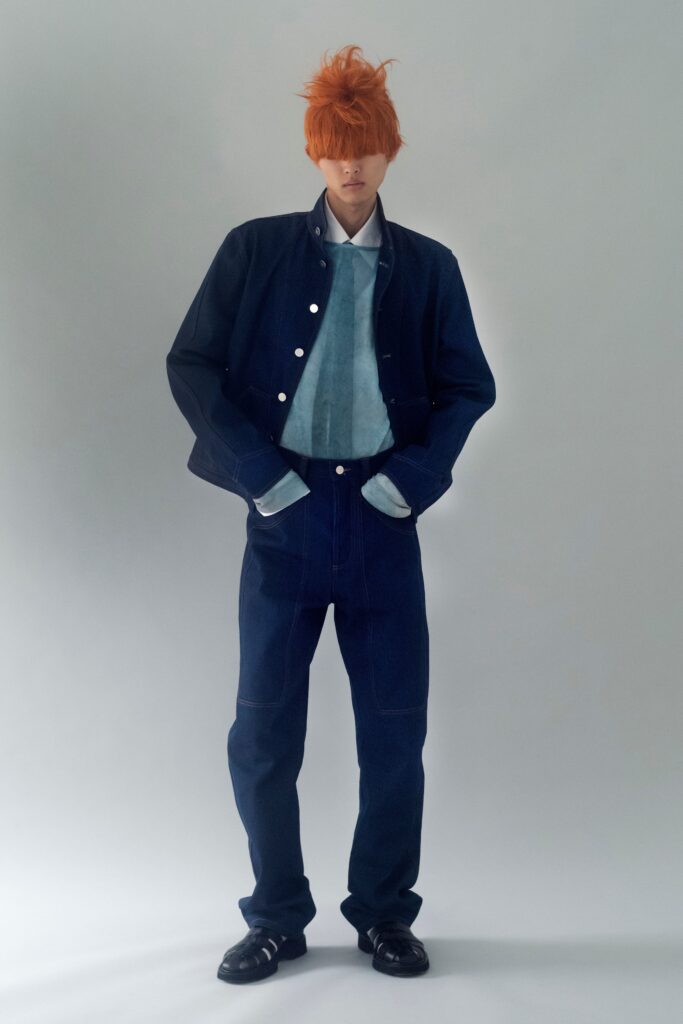 A relaxed blue denim jacket with long sleeves and collared shirt paired with straight-leg pants.