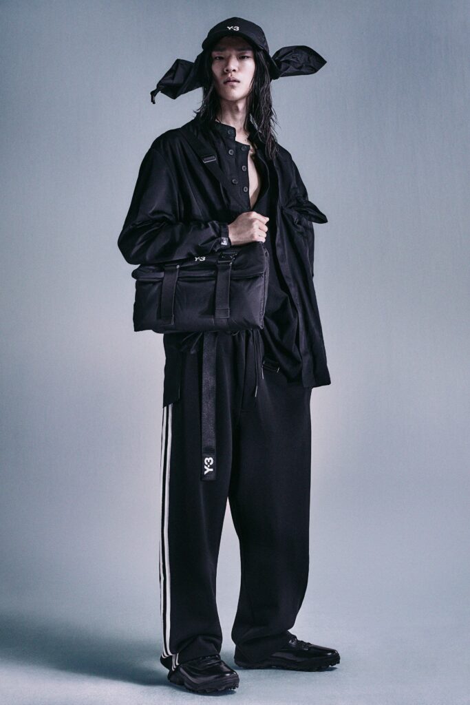 A relaxed black jacket with long sleeves and collared design, paired with matching striped pants.