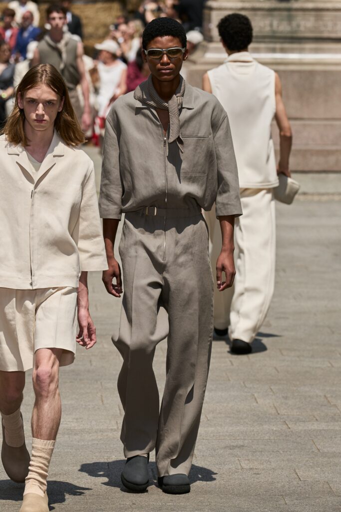 A relaxed beige cotton jacket with long sleeves and collared design paired with matching pants.