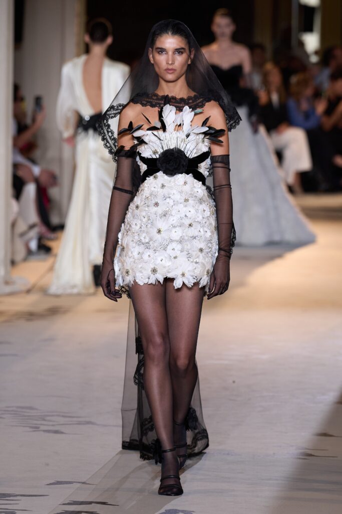 A fitted white floral off-shoulder dress with tiered design details.