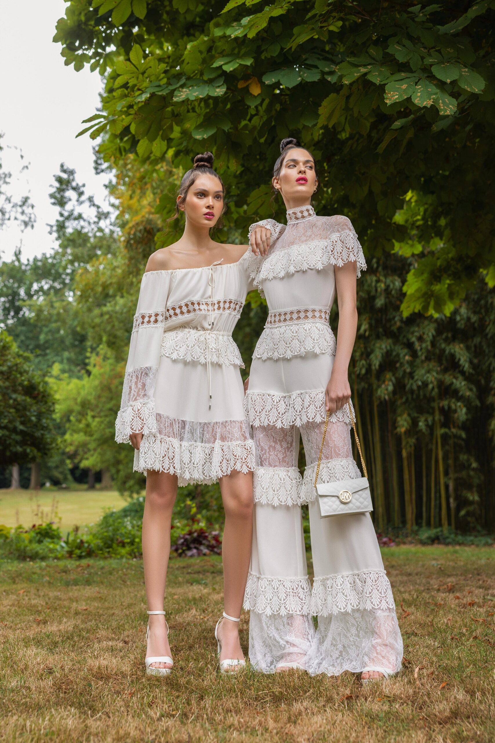 A fitted white lace outfit featuring a sleeveless dress and matching pants with a tiered design.