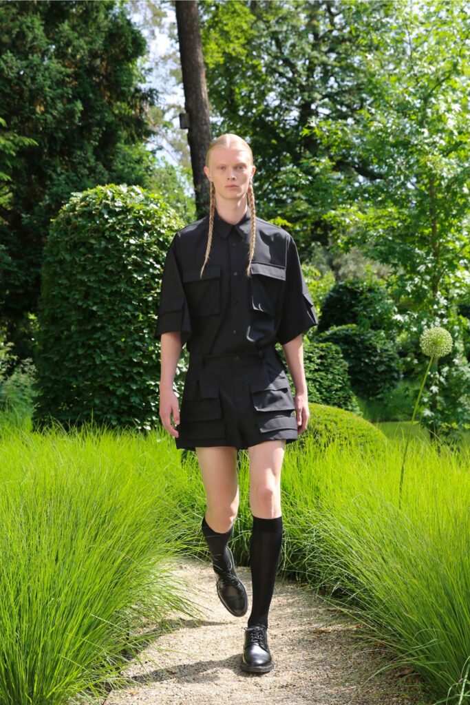 A relaxed black shirt with short sleeves and matching shorts, featuring a collared design.