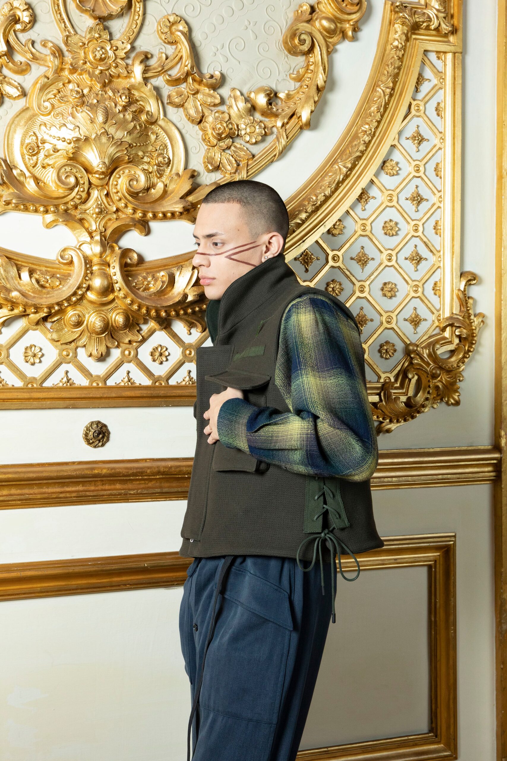 A relaxed fit long-sleeve collared jacket in green and blue cotton with layered details.
