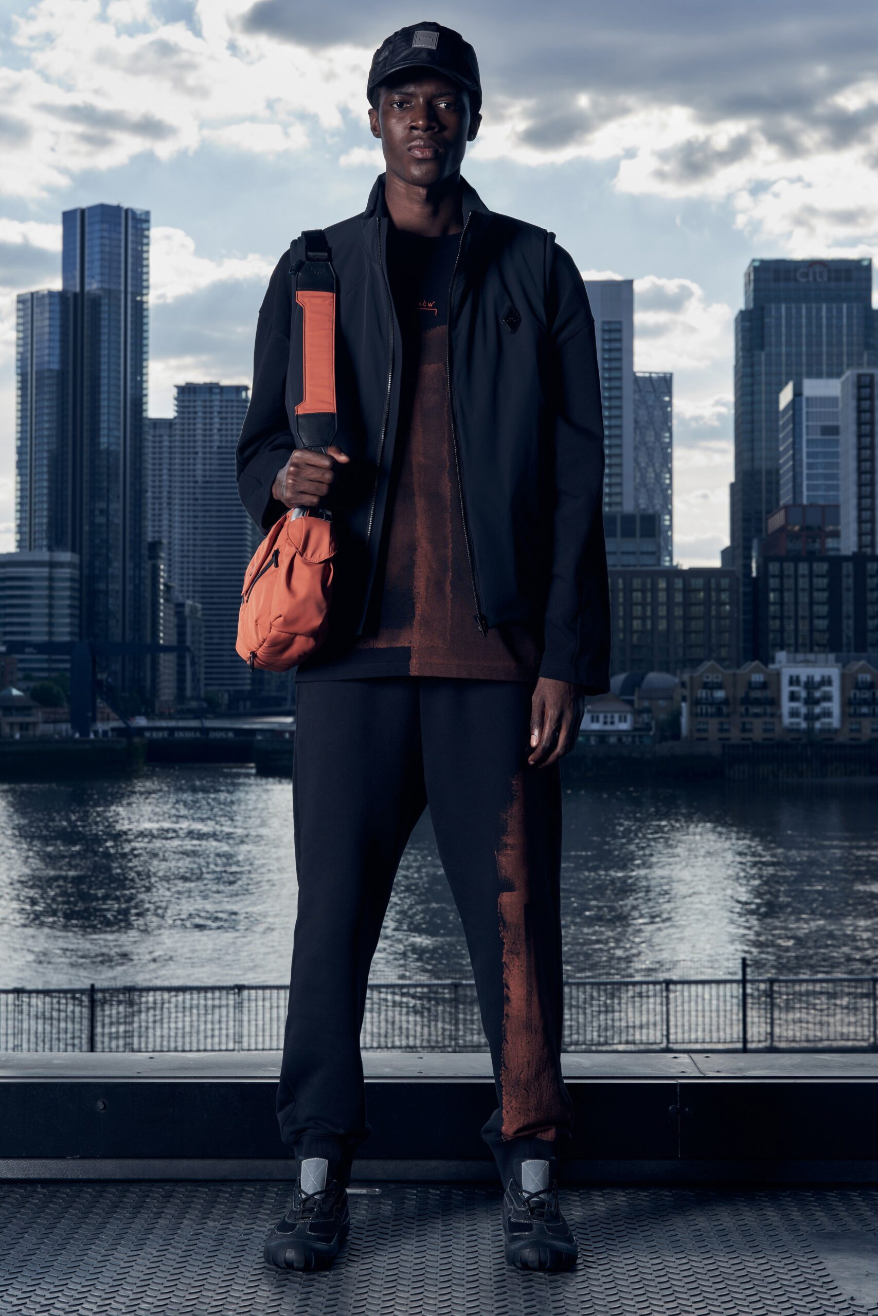 A relaxed black jacket with long sleeves and matching pants, featuring a zippered detail.