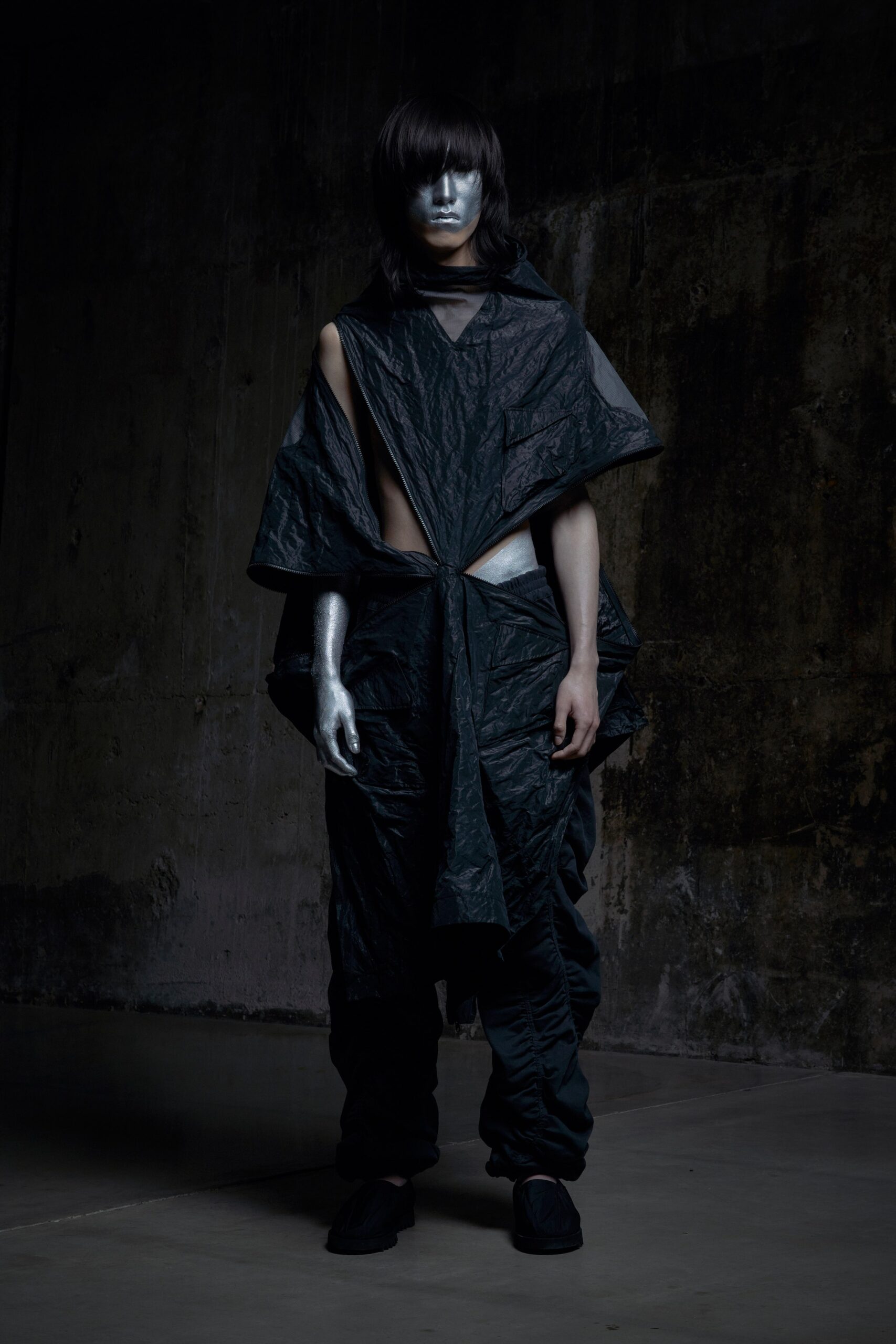 A relaxed black jacket with an asymmetric design paired with matching pants.