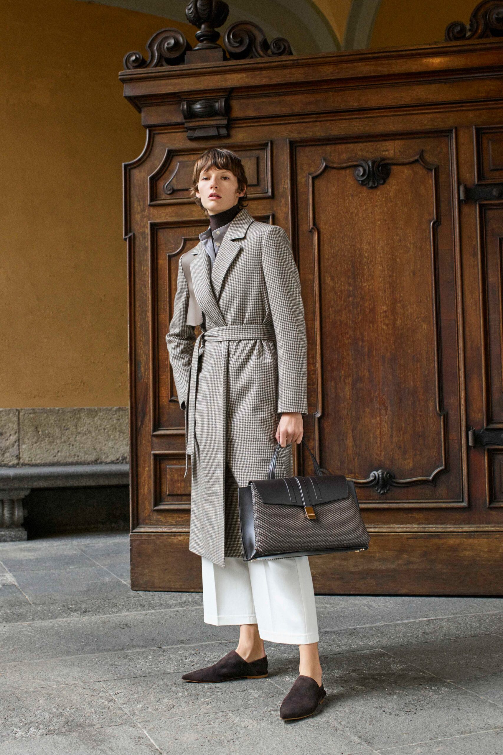 beige tailored coat with white pants