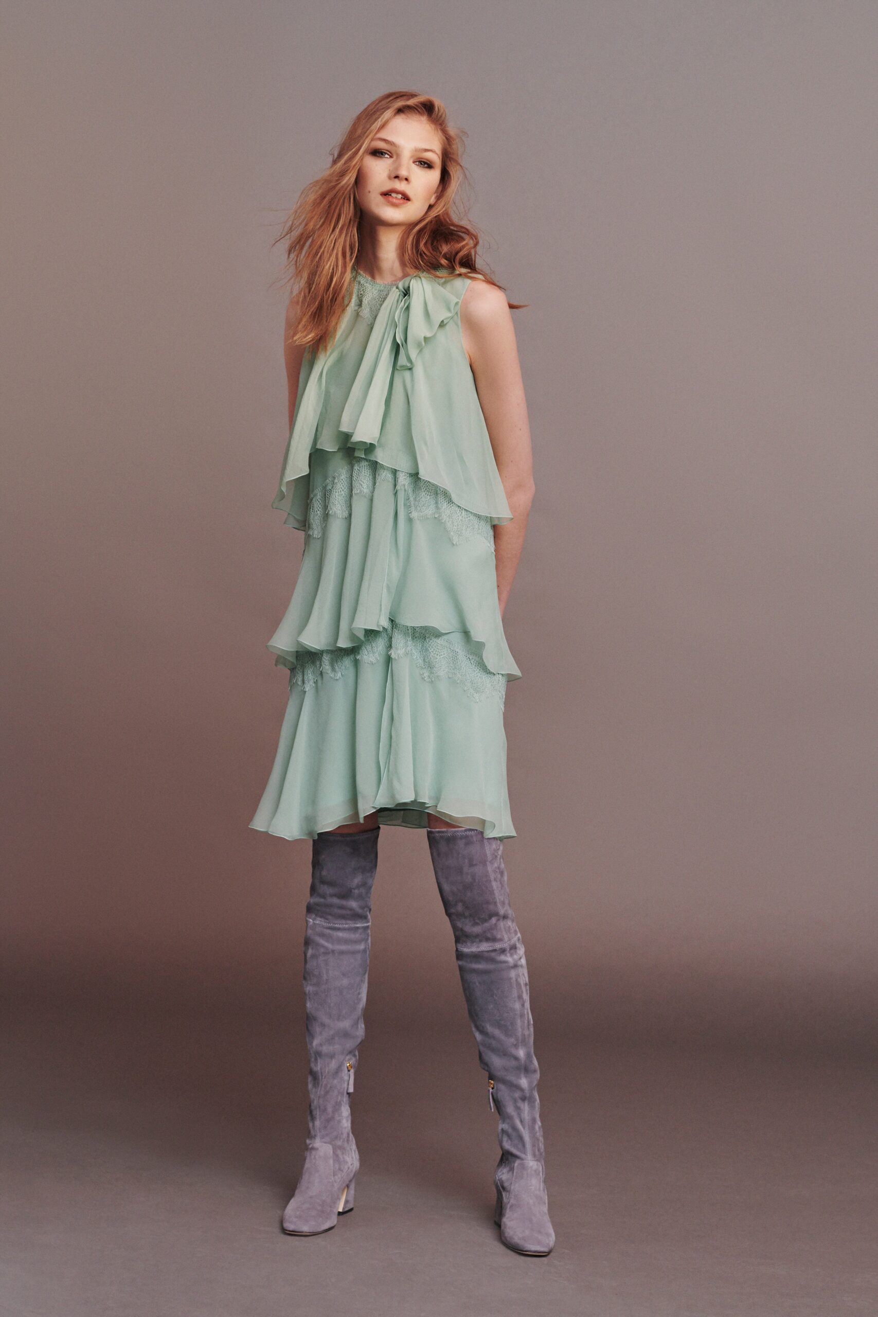 green tiered mini dress with gray boots