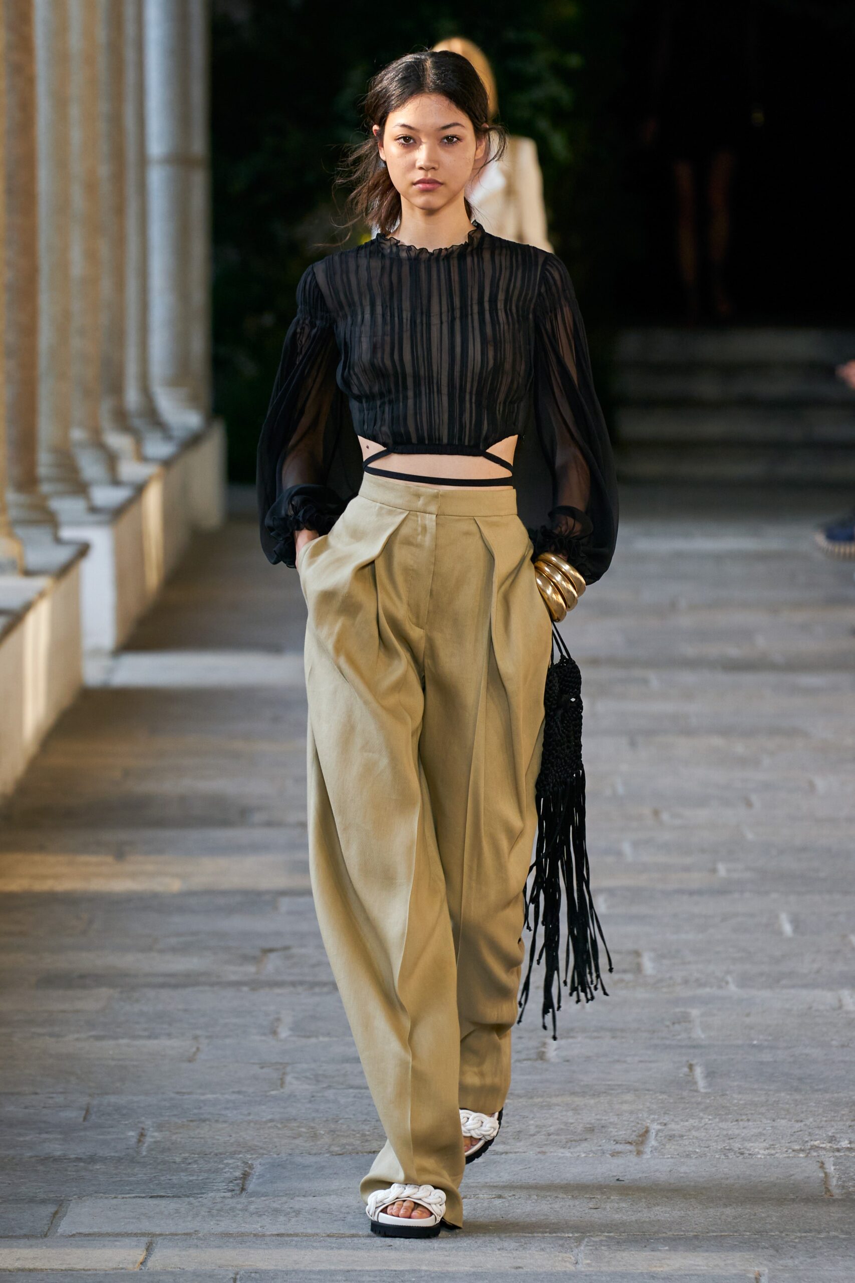 black silk blouse and beige pants