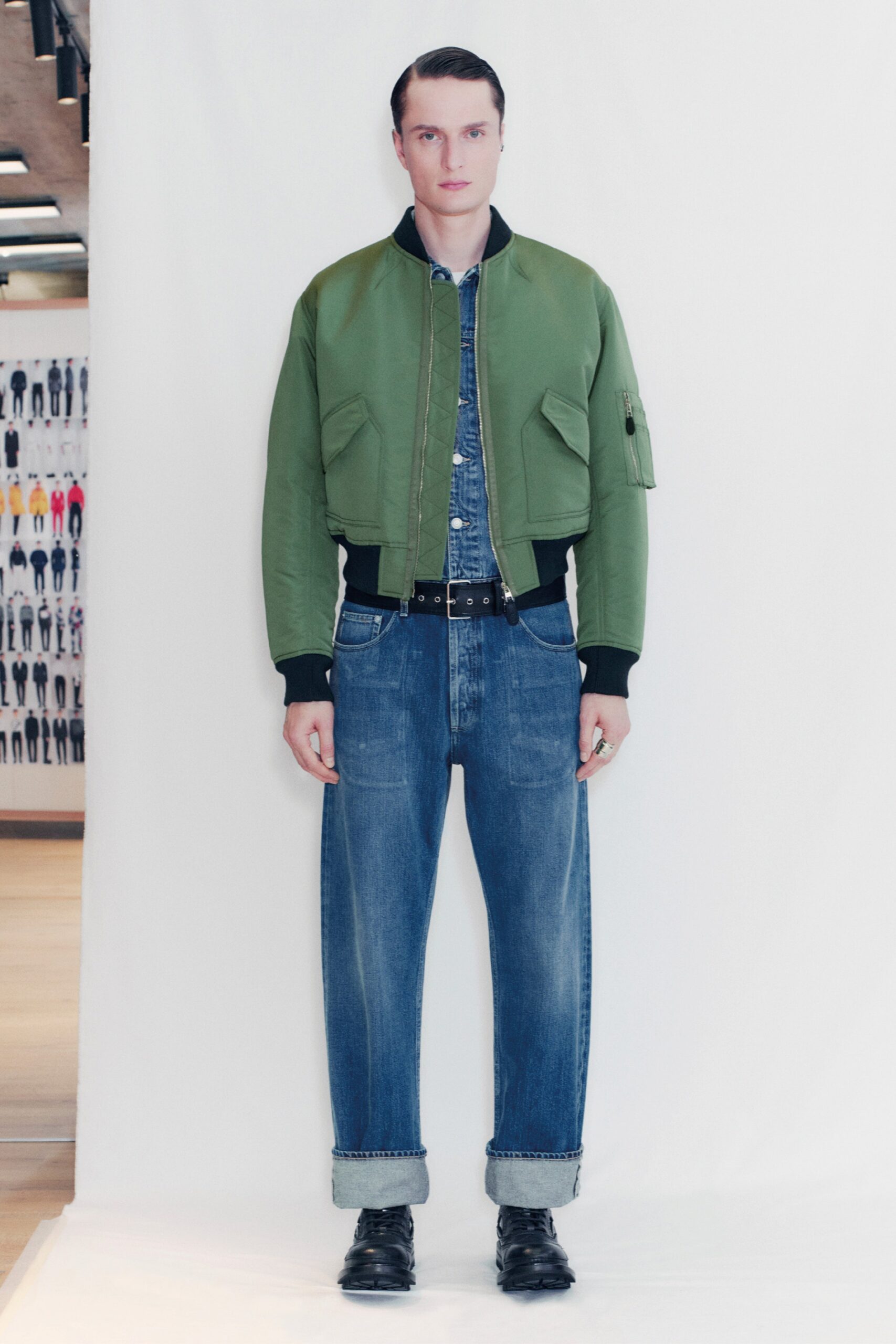 green fitted jacket with relaxed denim pants