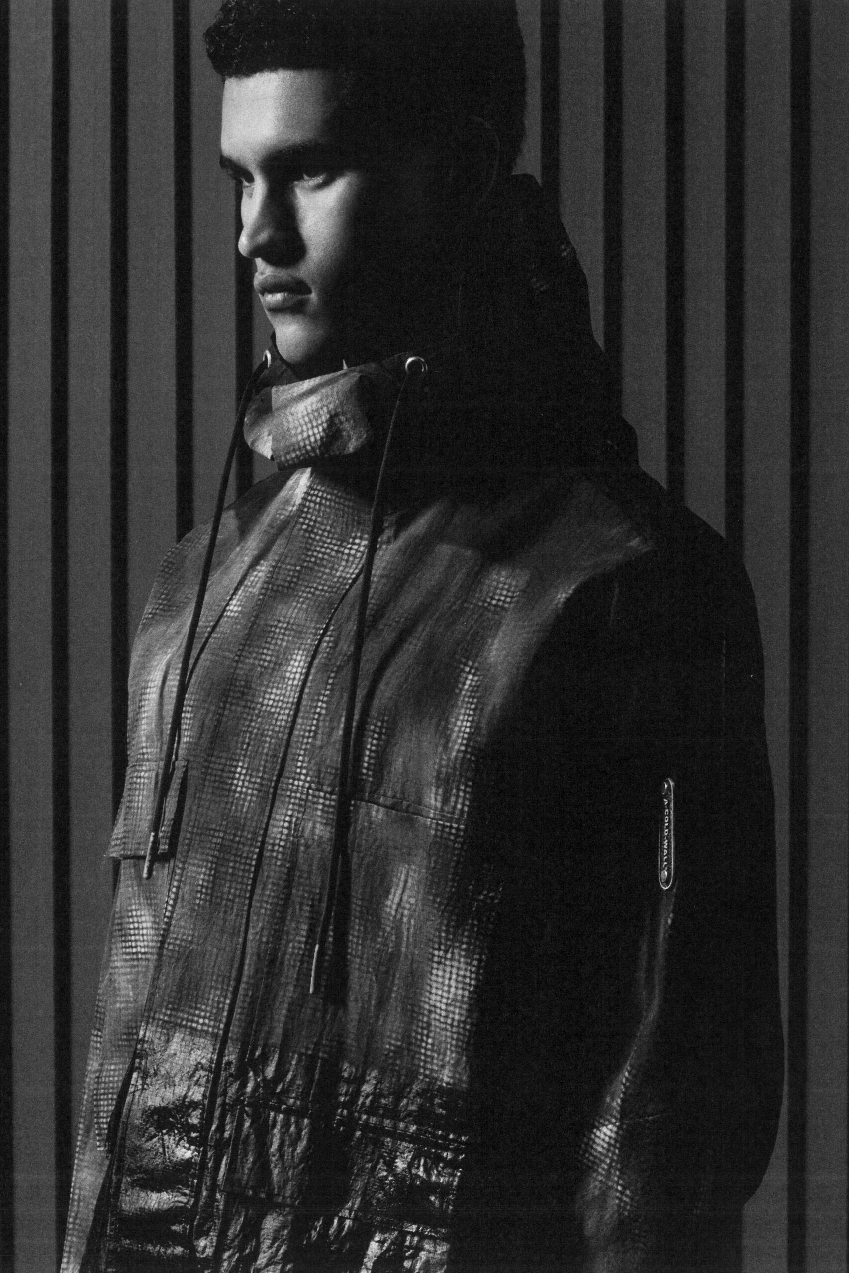 A relaxed black leather hooded jacket with long sleeves and zippered details.